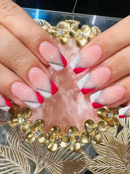 A striking design with angular red and white French tips separated by a fine silver glitter line.