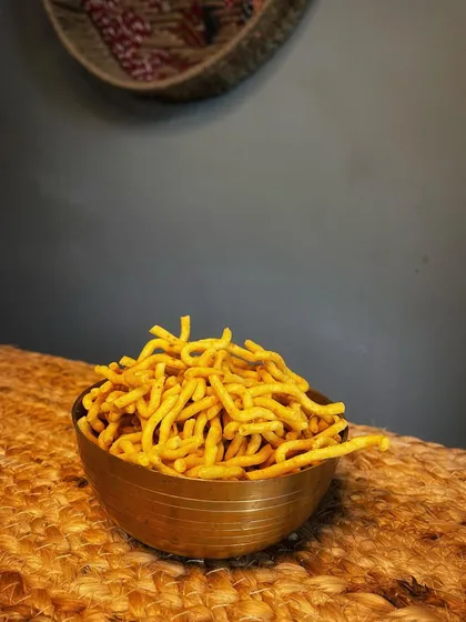 A bowl of our savoury besan sev, a classic Indian namkeen. It's a crunchy, flavourful snack that pairs perfectly with a hot cup of chai.