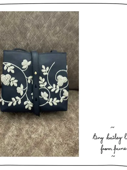 A close-up of a custom Tiny Bailey for our patron Sarita in Pune. She chose our classic white Lace embroidery on a deep Navy leather and added a detachable sling for more ways to wear it.