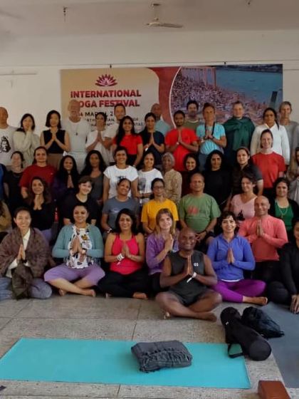 A group photo with students after a session at the International Yoga Festival in Rishikesh.