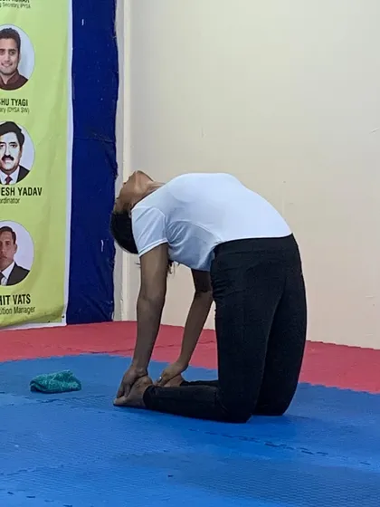 A close-up of a student in a perfect camel pose, showcasing her back flexibility and dedication.