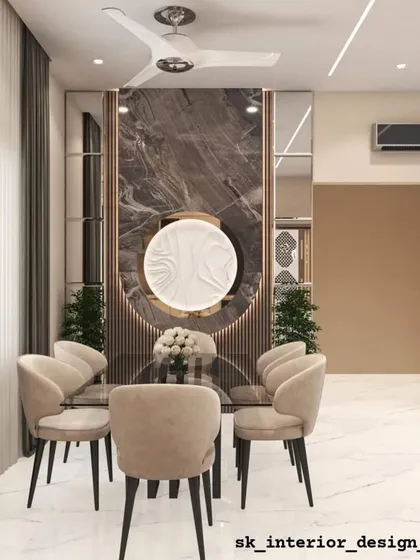 A cozy dining nook with a marble-clad feature wall and custom wall art. The neutral color palette of the chairs and table creates a calming and sophisticated dining experience.