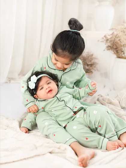 A playful moment with the older sister holding her baby sister. The genuine expressions are what I always aim to capture.