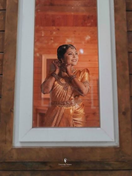 A bride looking at her reflection in a mirror, a classic and timeless getting-ready shot.