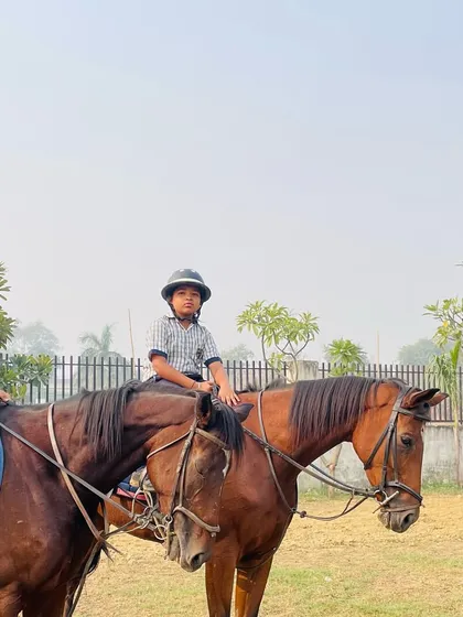 An instructor and two students pause for a photo during a riding session, showcasing the friendly and supportive learning environment at our academy.