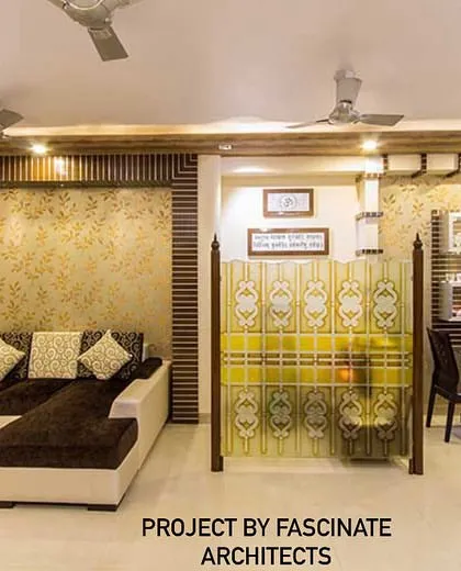This living room in Kharghar uses a combination of textured wallpaper and wood fluting to create a warm and inviting space. A glass partition provides a subtle division from the dining area while maintaining an open feel.