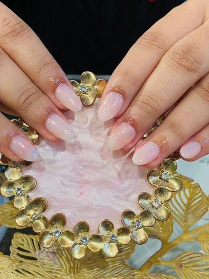 A perfect example of enhancing natural nails. This is a simple, clean, and healthy-looking set using a sheer pink strengthening gel.