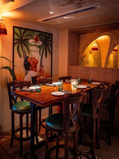 A high-top table at Los Cavos, perfect for small groups. The artwork and warm lighting contribute to the immersive, story-driven environment I aimed to create for this hospitality project.