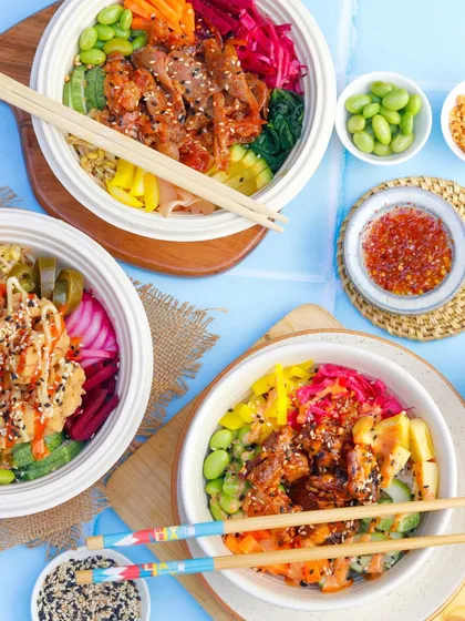 A colourful picnic-style flatlay of various poke bowls, creating a fresh and healthy vibe.
