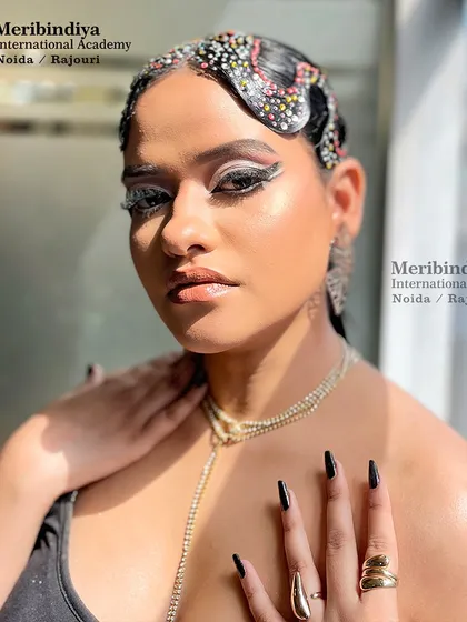This editorial look features sharp, black stiletto nails that add an edge to the graphic eyeliner and rhinestone-studded hairstyle.