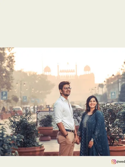 Capturing the essence of Delhi, this pre-wedding shot features the couple against the iconic backdrop of the Red Fort, blending their modern love story with historic charm.