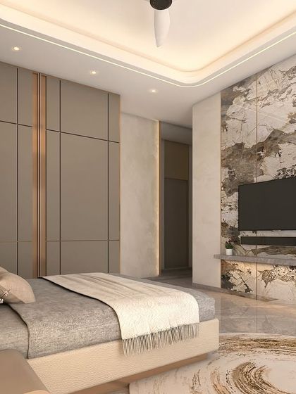Here, a striking marble feature wall serves as the centerpiece of the bedroom design. Its natural, dramatic pattern is balanced by the calm, neutral tones of the surrounding cabinetry and soft furnishings, creating a look of timeless luxury.