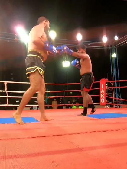 Exchanging punches in the semi-final. Our fighter's superior conditioning allowed him to maintain pressure.
