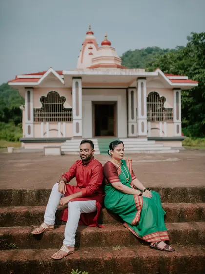 A serene pre-wedding portrait on the steps of a traditional temple. This setting adds a sense of peace and cultural heritage to the couple's photoshoot.