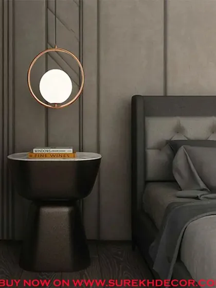 This graceful hanging light features a glowing globe within a copper-finished ring. The imported design is perfect for use as a bedside pendant or to add a touch of modern elegance to a reading nook.