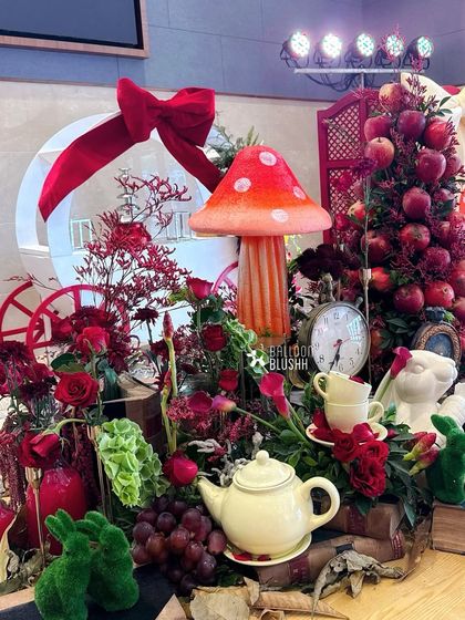 A rich and detailed centerpiece with an apple tree, teapot, and other whimsical elements, creating a feast for the eyes.