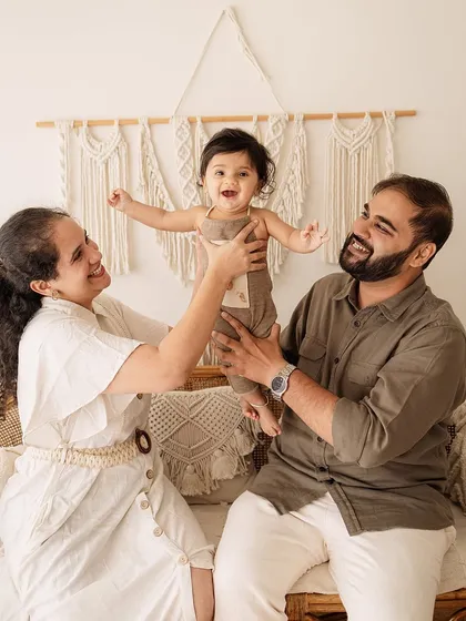 Another angle of the family playing, capturing the pure delight on the baby's face. These are the unscripted moments that tell the best stories.