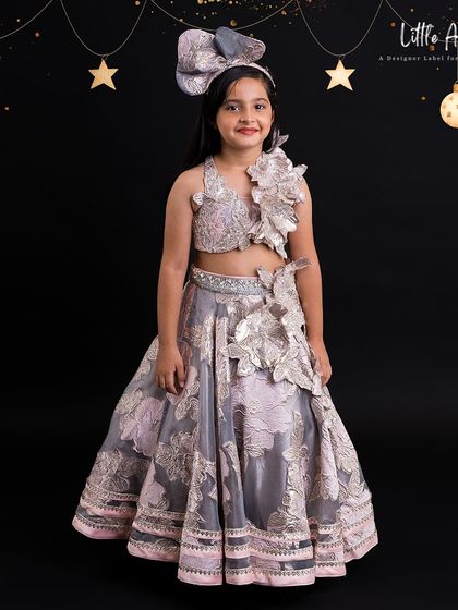 An embossed floral lehenga in grey and pink, featuring 3D flower details on the blouse and a voluminous skirt.