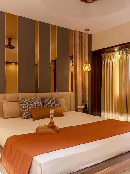A wide view of the luxurious bedroom, showing how the textured wall, warm lighting, and rich materials come together to create a sophisticated and inviting retreat.