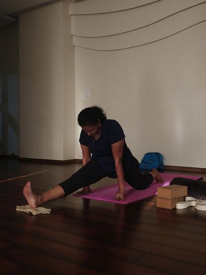 Working on hamstring flexibility with the help of a folded napkin under the heel. Simple props can be incredibly effective.
