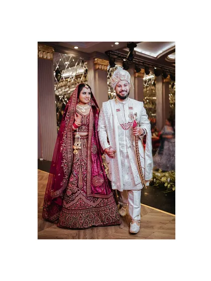 A stylish shot of the bride and groom walking together after their wedding ceremony.