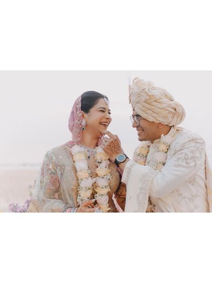 A playful and candid moment between Vedika and Yuvraj during their wedding ceremony. The genuine laughter and lightheartedness show a love that is fun and full of joy.