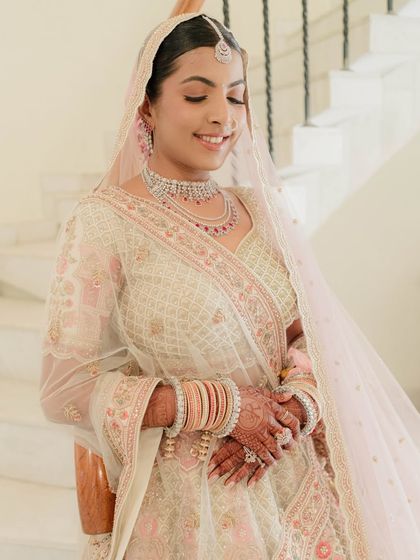 A candid, joyful moment. Nidhi’s makeup is designed to be long lasting and radiant, ensuring she looks perfect through all the happy tears and smiles.