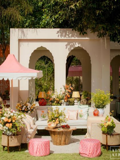 A lounge area at the 'Kesar Sehar' Haldi, set within modern white arches and furnished with hand-printed textiles. The design blended traditional elements with a clean, contemporary aesthetic.