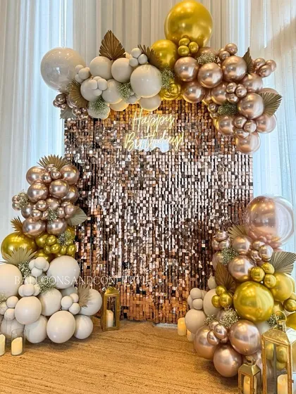 Another angle of the rose gold shimmer wall, showing how the balloon arrangement frames the backdrop to create a luxurious and inviting party atmosphere.