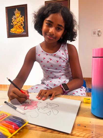 A young artist fully engaged in her drawing, showing the calm and concentration that creative activities can bring.