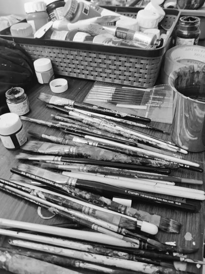 My tools of the trade. This black and white photo shows the beautiful mess of my paintbrushes after a productive session. Each one has helped tell a story on a wall somewhere.