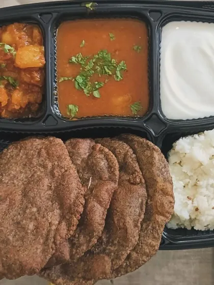 A special thali prepared for fasting, featuring Kuttu ki Poori, Aloo sabzi, Petha (pumpkin) sabzi, and Samak rice.