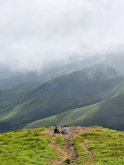 Two trekkers find a quiet spot to soak in the immense beauty of the Kudremukha landscape. We always encourage taking moments to appreciate the serenity.