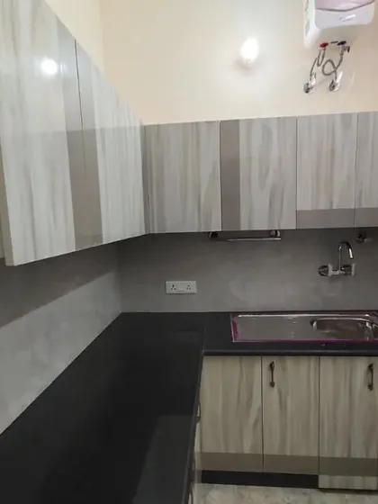 A different view of the rental kitchen, showing the L-shaped layout that maximizes counter space and storage in a compact area.