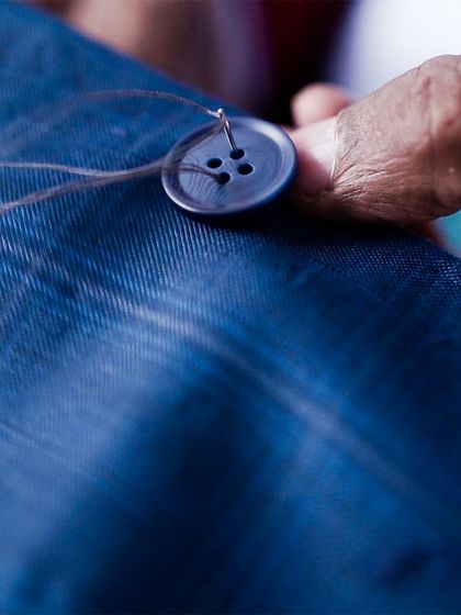 Stitching dreams into reality, one button at a time. This close-up shows the care and precision that goes into even the smallest details of our handmade garments.