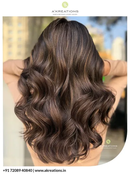 This is the glow-up you've been dreaming of. We created these dazzling warm brown highlights, styled into soft, luxurious waves that catch the light perfectly. This look brings incredible life and dimension to brunette hair.