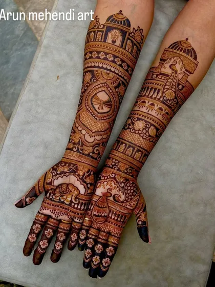 A beautiful design with a mix of traditional motifs, including a doli, kalash, elephants, and peacocks.