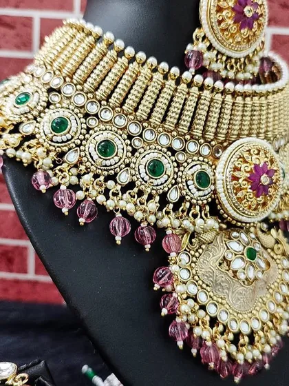A close-up view of the intricate layers and colorful stones of this statement bridal necklace.