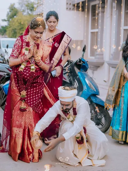 The groom performing a ritual at the bride's feet as they prepare to enter their new life together.