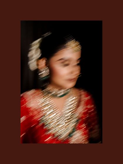 An artistic motion-blur photo of the bride, creating a dreamy and ethereal feel that focuses on the colors and sparkle of her attire.