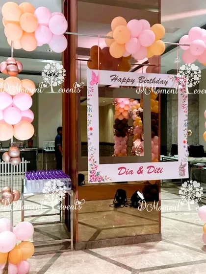 A fun selfie frame for the twins' boho-themed party. The frame is decorated with pastel balloons and provides a great photo opportunity for guests.