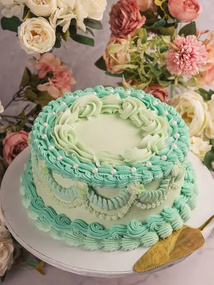 Vintage Victorian charm at its best. My dark chocolate ganache layer cake is frosted in shades of Tiffany blue with crisp Lambeth detailing.