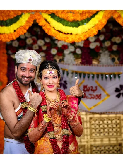 A fun and happy portrait of the newlyweds giving a thumbs-up. It's great to capture the couple's personality and joy right after the ceremony.