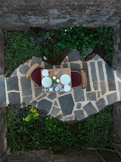 An aerial view of a private dining table set within the stone ruins at Sanctuary Bar. This unique feature offers an incredibly intimate and historic setting for a special meal.