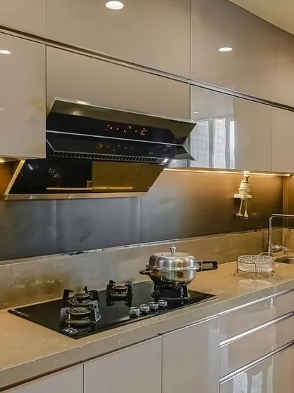 A close-up of the hob and chimney in the acrylic parallel kitchen, highlighting the clean lines and modern appliances.