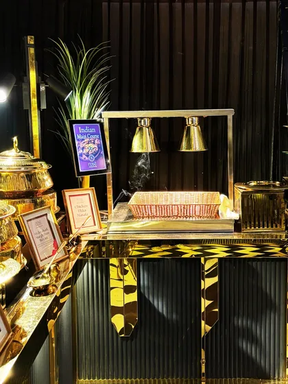 A live station for Indian breads, kept warm under heat lamps. This setup ensures that your guests enjoy fresh and hot naan and rotis with their main courses.