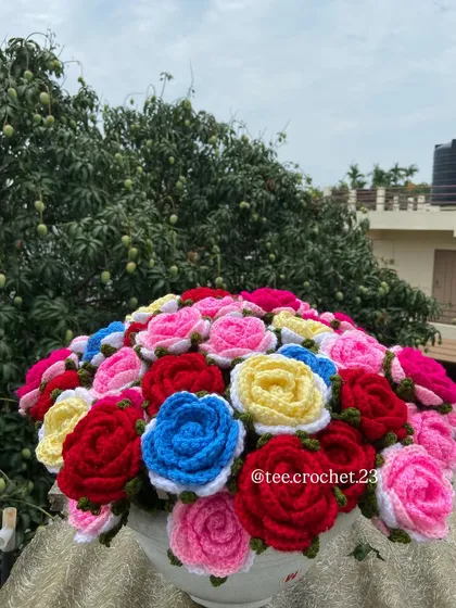 The full multi-colored rose bouquet arranged in a vase.