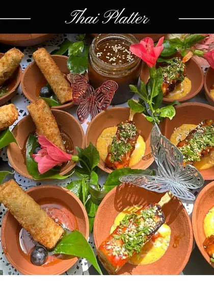 My Thai Platter offers a taste of Thailand's vibrant street food. It includes crispy Thai Cigar Rolls and savoury Paneer Satay skewers with a tangy dipping sauce.