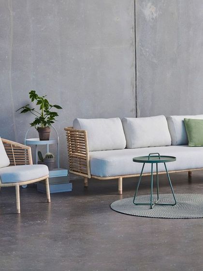 Another look at my customizable cane sofa set, this time with off-white fabric. I can source different materials and colors based on your specific request for a truly personal furniture piece.