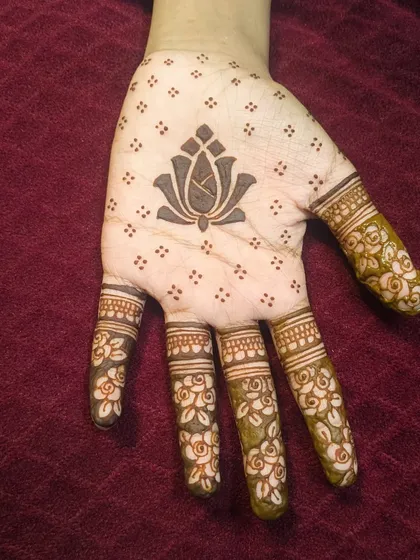 The front of the minimal design, with a lotus motif on the palm and simple floral details on the fingers. It's light, airy, and very pretty.